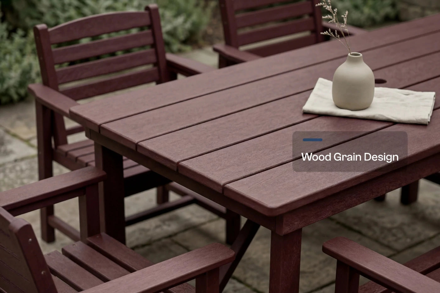 Wooden outdoor furniture set with a table and chairs on a patio.