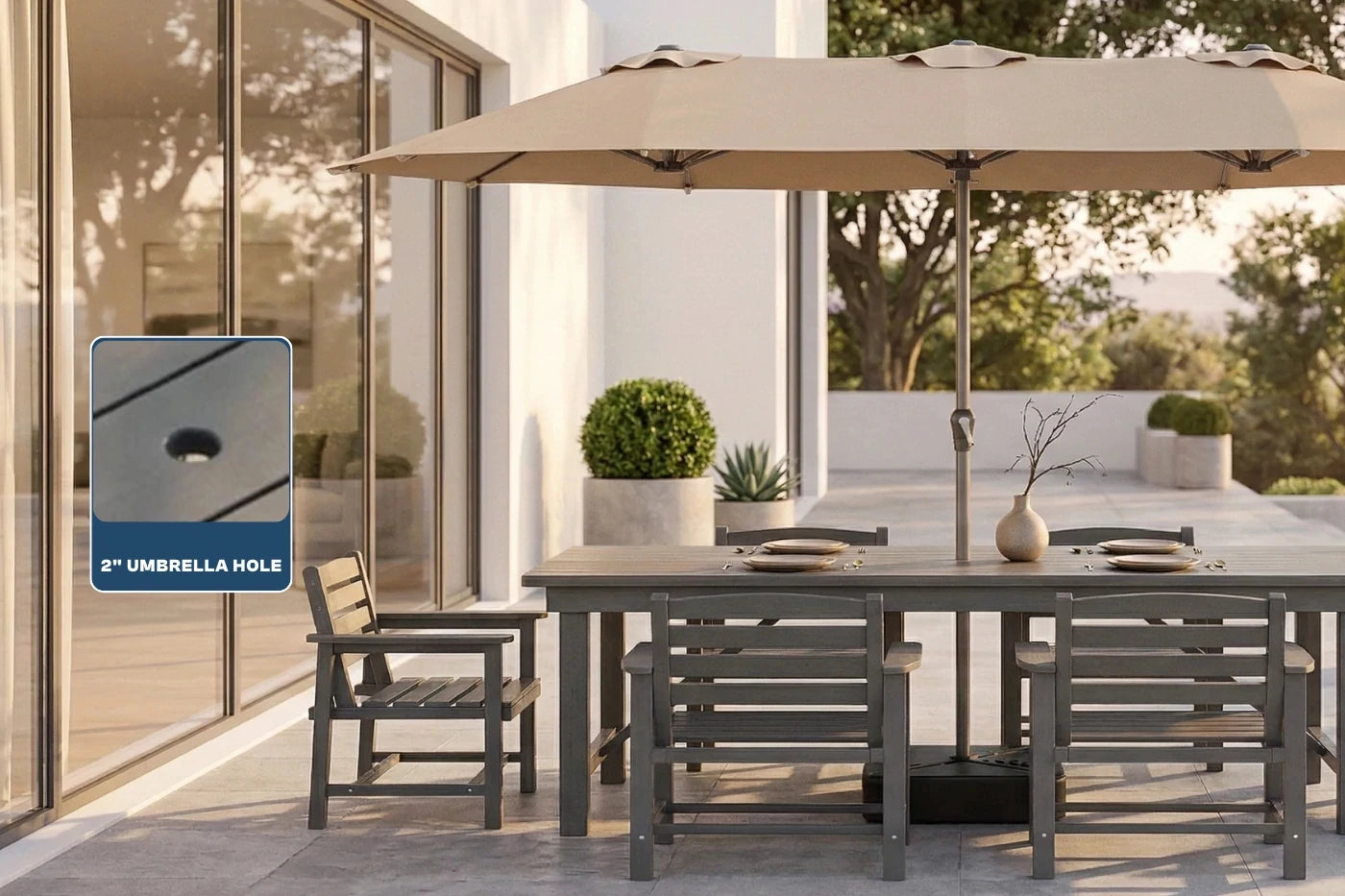 Outdoor patio set with a large umbrella and table on a patio.