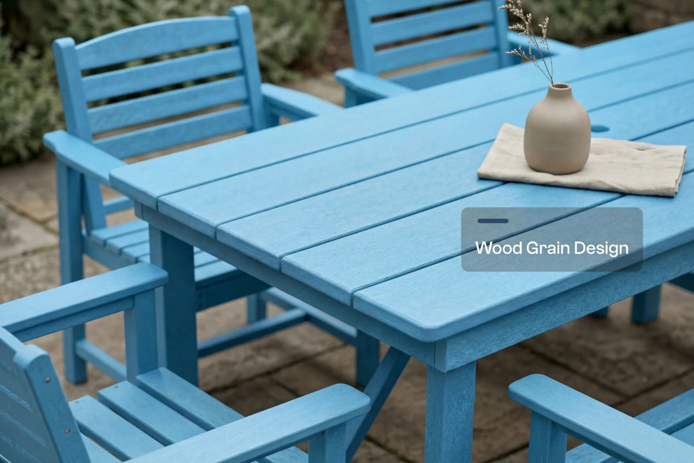 Blue outdoor furniture set with a table and chairs on a patio.