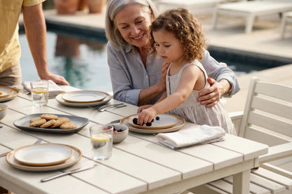 Woman and child at a dining table by a poolside