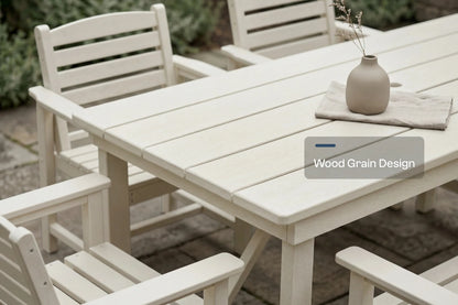 White outdoor furniture set with a table and chairs on a wooden deck.