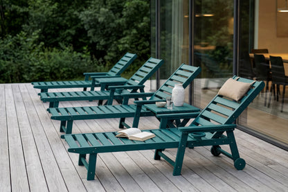 Green lounge chairs on a wooden deck with a modern building in the background
