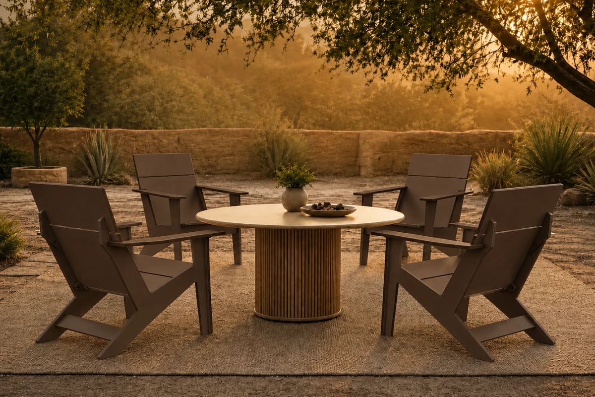 A 5-piece outdoor patio dining set featuring four coffee Adirondack-style chairs and a round slatted pedestal table, arranged on a stone patio in a garden setting during golden hour.