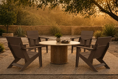 A 5-piece outdoor patio dining set featuring four coffee Adirondack-style chairs and a round slatted pedestal table, arranged on a stone patio in a garden setting during golden hour.