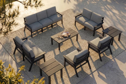 Outdoor furniture set with gray cushions on a stone patio