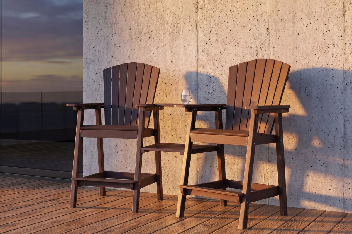 Two coffee-colored chairs on a wooden deck with a concrete wall in the background.