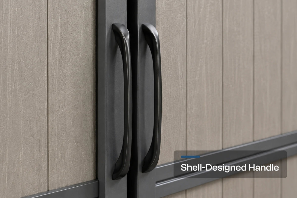 Close-up of a pair of black shell-shaped cabinet handles mounted on a gray door, with a text overlay reading 'Shell-Designed Handle'.
