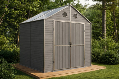 A gray resin storage shed with double doors and a polycarbonate roof, shown on a wooden deck in a grassy backyard with trees.