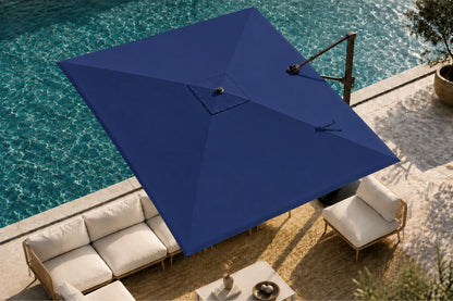 A large patio umbrella in a deep navy blue shade, positioned over a modern outdoor seating area next to a swimming pool.
