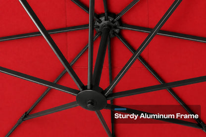 Close-up underside view of a red patio umbrella showing the black aluminum frame ribs and central hub, with a text overlay reading 'Sturdy Aluminum Frame'.